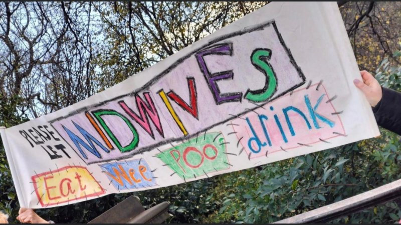 March with midwives banner raising awareness of the current midwife shortage 